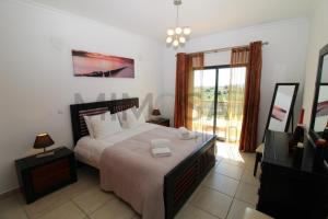 a bedroom with a large bed and a window at Alba Mar in Lagos