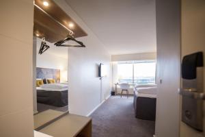 Una habitación de hotel con dos camas y un espejo. en Comwell Hvide Hus Aalborg, en Aalborg