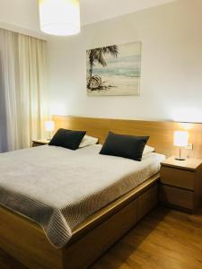 Postel nebo postele na pokoji v ubytování Apartamenty Rodzinne z ogródkiem