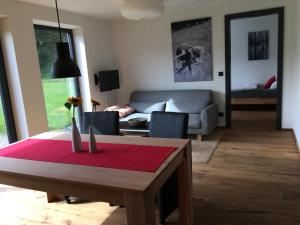a living room with a table and a couch at Ferienwohnung Berglieb in Oberstdorf