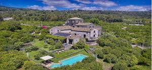una vista aerea di una grande casa con piscina di Borgo degli Aranci a Fiumefreddo di Sicilia