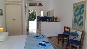 a bedroom with a bed and a table and chairs at Bungalows Ingrid in Tolo