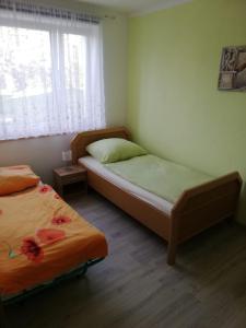 1 dormitorio con 2 camas y ventana en Ferienwohnung, Monteurwohnung, en Hauswalde