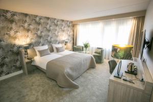 Postel nebo postele na pokoji v ubytování Van der Valk Hotel Avifauna