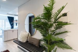 a palm tree in a living room with a mirror at Wow! Super Luxury Apartment in Dubai Marina - 1BR RO in Dubai