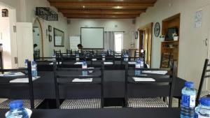 a class room with tables and chairs with water bottles at Dive Inn Guesthouse in Pongola +76 photos