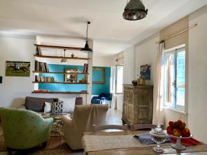 a living room with a couch and a table at Capannacce Organic and Horse Farm in Rapolano Terme