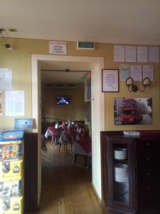a restaurant with a dining room with a table and chairs at London Cafè in Castelnovo neʼ Monti