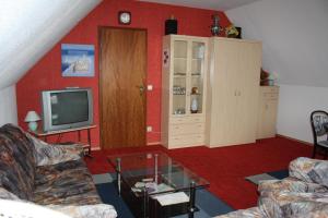 a living room with a couch and a tv at Ferienwohnung Neumann in Berlin