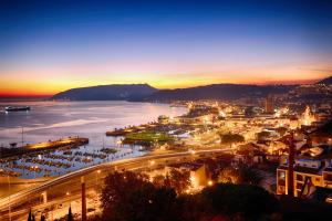 a view of a city at night with a harbor at RM The Experience - Small Portuguese Hotels in Setúbal