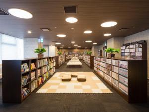 uma biblioteca com várias estantes de livros e um corredor com sidx sidx em Himeji Castle Grandvrio Hotel em Himeji