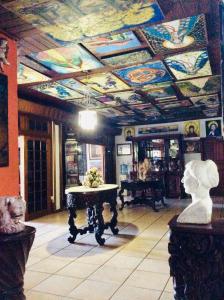 a room with a painted ceiling with a table in it at La Posada del Arcangel in Managua