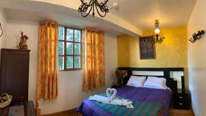Katil atau katil-katil dalam bilik di Hostal Qolqampata