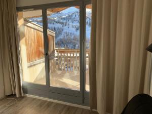 a sliding glass door with a view of a mountain at Appartement de vacances à Isola 2000 in Isola 2000