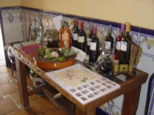 a table with a bunch of bottles of wine at HOSTAL RESTAURANTE MILAN II in San Clemente +11 photos