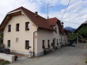 a large white building with red roof at Apartments Bernard in Bled
