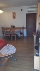 a living room with a table and a dining room at apartmani vraničić in Vis +7 photos