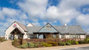 a building with a fence in front of it at Sessile Oak, Llanelli by Marston's Inns in Llanelli