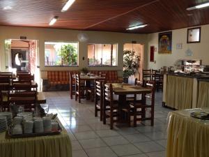 a dining room with tables and chairs in a restaurant at Palace Hotel Barretos in Barretos