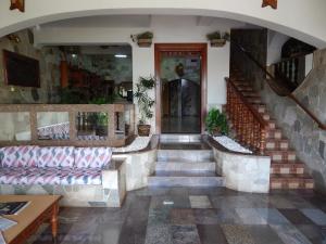 a lobby of a building with stairs and a door at Palace Hotel Barretos in Barretos