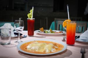 a table with a plate of food and drinks at Mallorca Hotel  in Mexico City