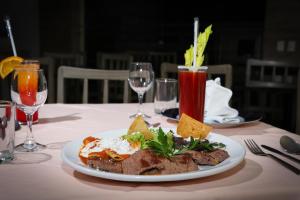 - une assiette blanche avec de la nourriture sur une table et des verres à vin dans l'établissement Mallorca Hotel , à Mexico 32 autres photos