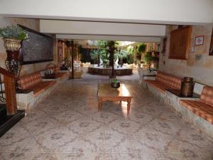 a lobby with couches and a table in a building at Palace Hotel Barretos in Barretos