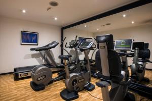 a gym with treadmills and elliptical machines at FlyOn Hotel & Conference Center in Bologna