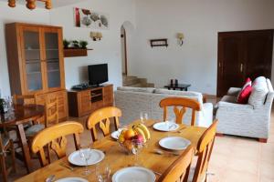 a dining room with a table and chairs with fruit on it at Villa Susan Ibiza in San Antonio