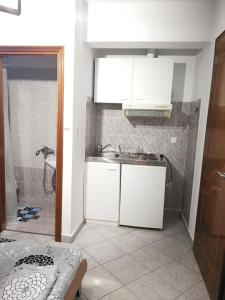 a kitchen with a sink and a counter top at Iliana's house in Naousa Imathias +47 photos