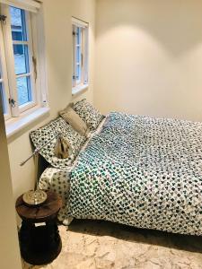 a bedroom with a bed with polka dot sheets at Apple Cottage in Vejby