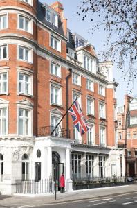 a large building with a flag on top of it at The Cadogan, A Belmond Hotel, London in London