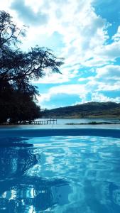 a view of a body of water with a tree at rancho california rancho beira d'água Delfinopolis in Delfinópolis