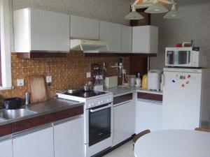 根特的住宿－GUESTROOMS BIJ HET STATION VAN DRONGEN，厨房配有白色橱柜和炉灶烤箱。