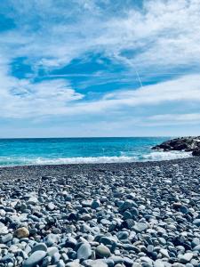 a large group of rocks on a beach at Villa Bagatelle - Luxury apartment in Nice