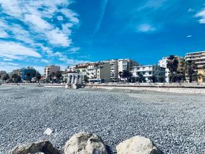 a rocky beach with buildings in the background at Villa Bagatelle - Luxury apartment in Nice