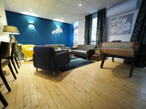 a living room with a couch and a table at Hôtel Le Biarritz - Vichy in Vichy