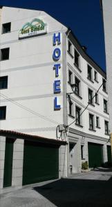 a white building with a sign for a hotel at Hotel Casa Benilde in Palas de Rei