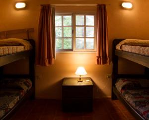 a room with two bunk beds and a lamp on a table at Cabañas MARE PARADISO in Costa del Este +36 photos