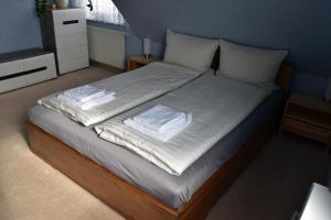 a bedroom with a bed with white sheets and pillows at Apartment A'la Karol in Świnoujście
