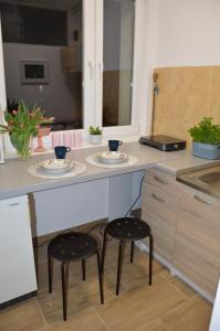 a kitchen with two stools sitting under a counter at Good Time in Szczecin in Szczecin
