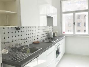 a white kitchen with a sink and a window at Bright, lovely and quiet apartment at the heart of Vienna, Nachmarkt, City center in Vienna
