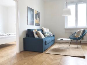 a living room with a blue couch and a chair at Bright, lovely and quiet apartment at the heart of Vienna, Nachmarkt, City center in Vienna