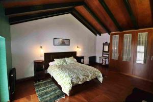 a bedroom with a bed and a wooden ceiling at Casa Lugar O Campón in Valdoviño