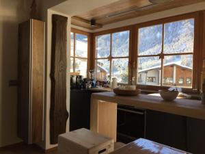a kitchen with a large window with a mountain view at Ciasa David Marebbe in San Vigilio Di Marebbe