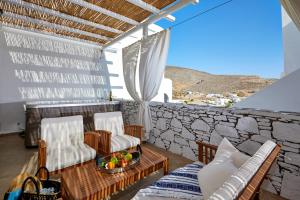 a balcony with two chairs and a table with at Vrahos Boutique Hotel in Karavostasi