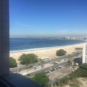 a view of a beach and the ocean from a building at Apartamento Praça do Lido in Rio de Janeiro