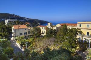 a group of buildings on a hill next to the ocean at Amore Rentals - Appartamento Tramontano in Sorrento