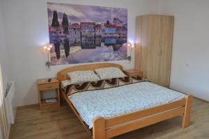 a bedroom with a bed and a painting on the wall at Sobe Mira in Trebinje
