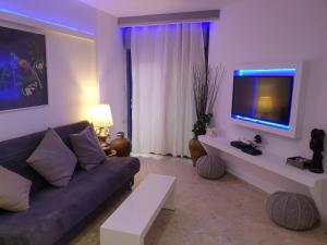 a living room with a couch and a flat screen tv at רויאל פארק1 in Eilat
